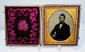 Victorian cased portrait of a gentleman in dark formal attire with white shirt, bow tie, and prominent sideburns