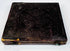Mid-19th-century photographic case showing embossed floral ornament, worn spine, and original metal closure hardware