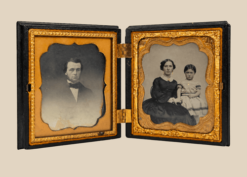 Antique Victorian daguerreotype case opened to reveal two 19th-century portraits