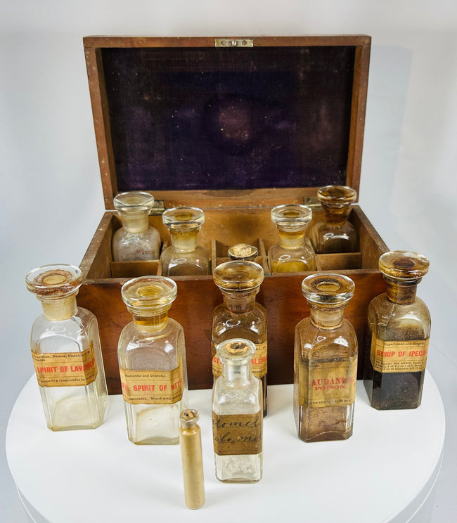 antique Victorian apothecary medicine box with labeled glass pharmacy bottles