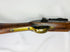 Detailed view of the Snider-Enfield brass trigger guard and steel lockplate set in a worn 19th-century walnut stock.