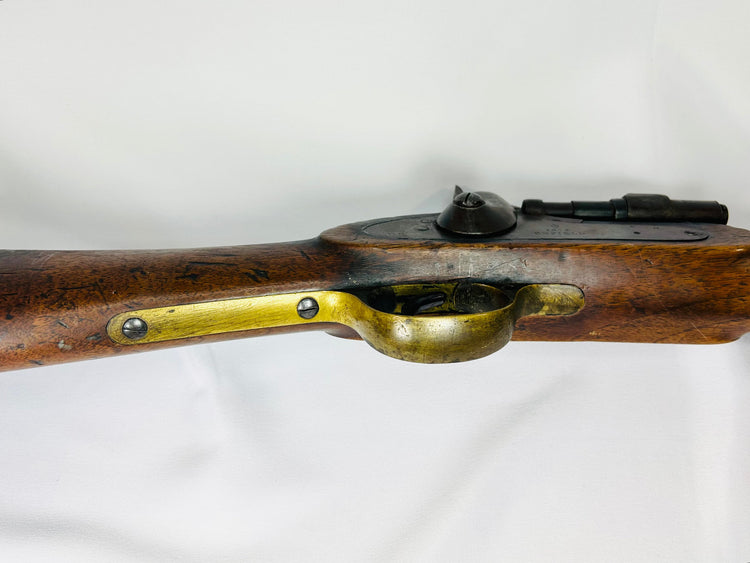 Detailed view of the Snider-Enfield brass trigger guard and steel lockplate set in a worn 19th-century walnut stock.