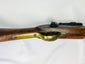 Detailed view of the Snider-Enfield brass trigger guard and steel lockplate set in a worn 19th-century walnut stock.