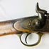 Close-up of the Snider-Enfield percussion-style hammer, trigger assembly, and engraved lockplate dated 1864.