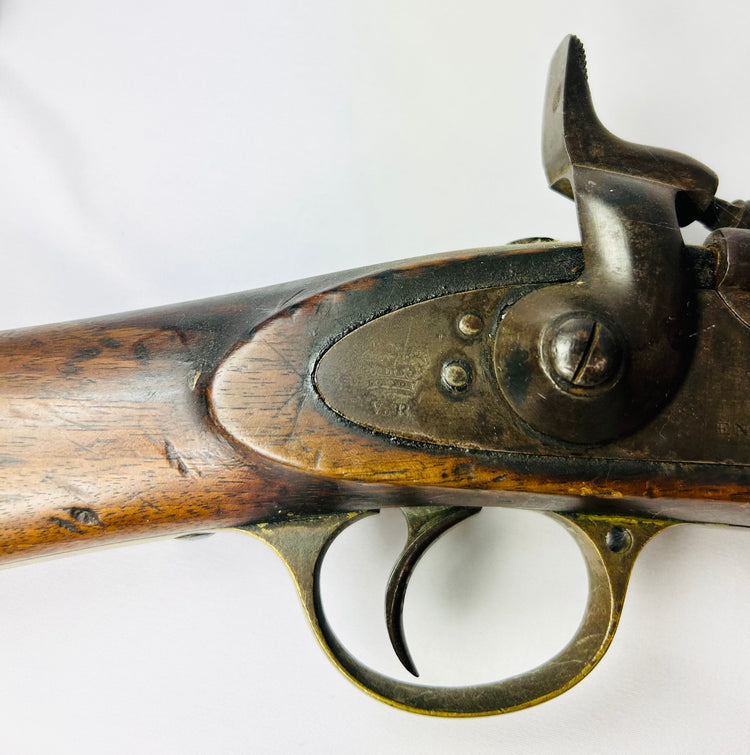 Close-up of the Snider-Enfield percussion-style hammer, trigger assembly, and engraved lockplate dated 1864.