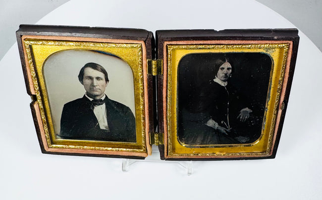 Early photographic daguerreotype portraits of a man and woman in antique Union case