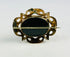 Detail of Gothic Revival openwork on a gold-plated Victorian mourning brooch.