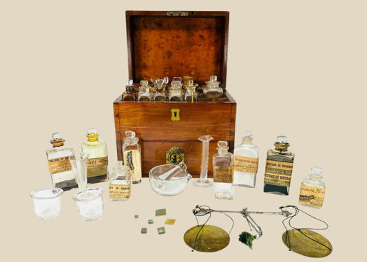 Antique Victorian apothecary box crafted in mahogany with brass fittings, containing original glass bottles with labels, balance scales, mortar and pestle, and chemist’s tools, late 19th century.