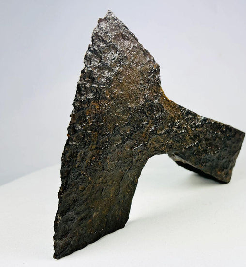 Ancient medieval iron axe head with broad bearded blade and hollow socket, Viking and early European design, circa 10th–14th century CE.