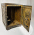 Vintage cast iron bank shaped like a safe with detailed front panel