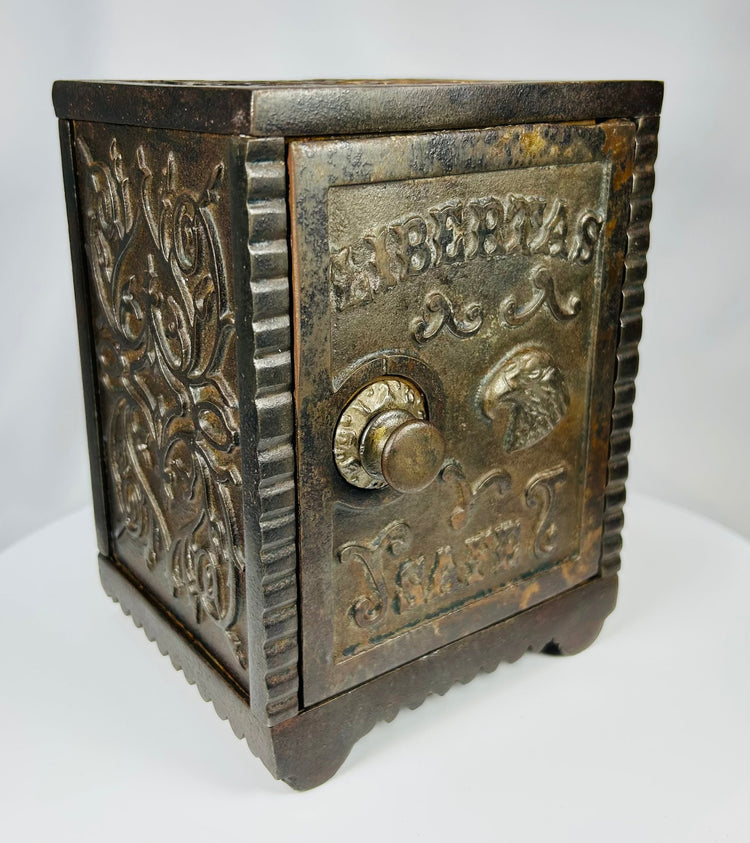 Early 20th century cast iron safe bank with hinged door and coin slot