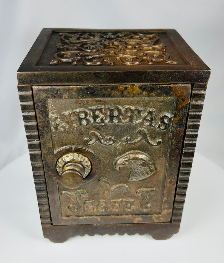 Antique cast iron still bank modeled as a safe with LIBERTAS SAFE lettering
