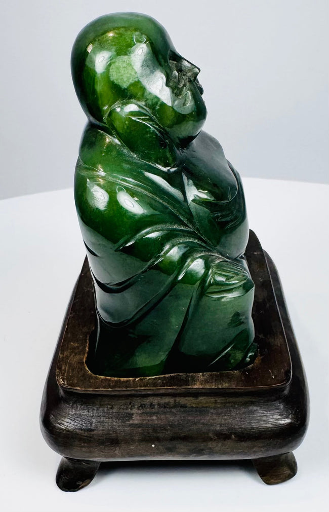 Opposite side view of carved Chinese Budai figure showing polished hardstone and layered robe folds