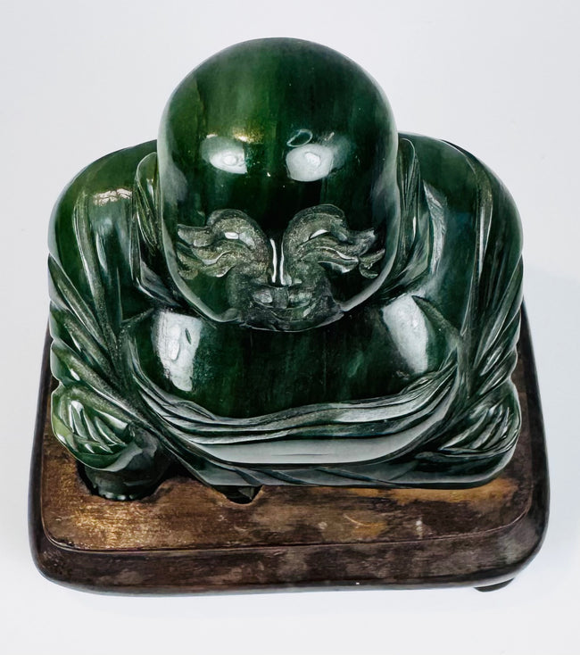 Top view of Chinese green hardstone Budai figure showing carved head, shoulders and robe details