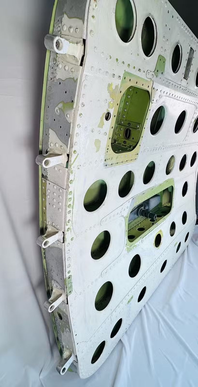 Angled rear view of the USAF aircraft cargo door with green structural framework and riveted aluminum skin