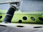 Close-up of the Boeing aircraft cargo door latch mechanism and surrounding aluminum riveted panel