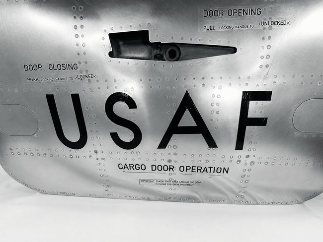 Detailed view of the Boeing aircraft cargo door latch, USAF lettering and original cargo door operation markings