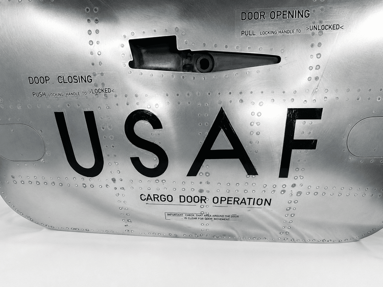 Detailed view of the Boeing aircraft cargo door latch, USAF lettering and original cargo door operation markings