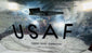 Lower section of the aircraft cargo door with bold USAF lettering, rivets and cargo door operation stencil