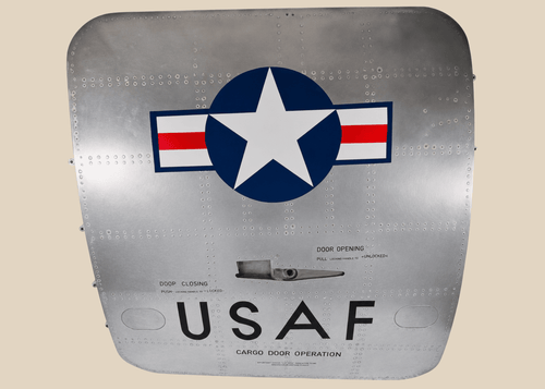 Full front view of a Boeing 737 USAF aft cargo door with Star and Bars insignia and polished aluminum skin
