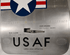 Close-up of the upper USAF Boeing 737 cargo door showing the Star and Bars insignia and aircraft rivet pattern