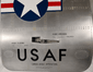 Close-up of the upper USAF Boeing 737 cargo door showing the Star and Bars insignia and aircraft rivet pattern