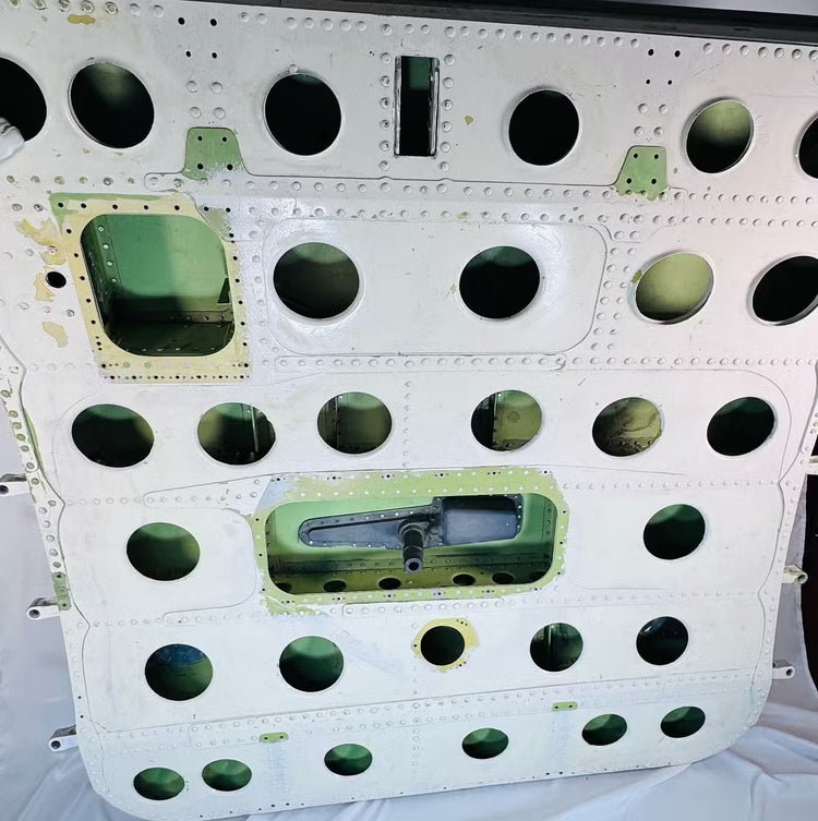 Perforated internal aluminum structure of a Boeing 737 military cargo door with weight-saving lightening holes