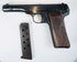 Deactivated FN Browning Model 1922 displayed with its magazine removed, revealing slide lettering and aged steel surfaces.