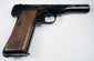 FN Browning Model 1922 with a long steel slide, checkered walnut grip, and a single slotted grip screw.