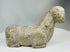 African stone sculpture with mottled tones and expressive carved details