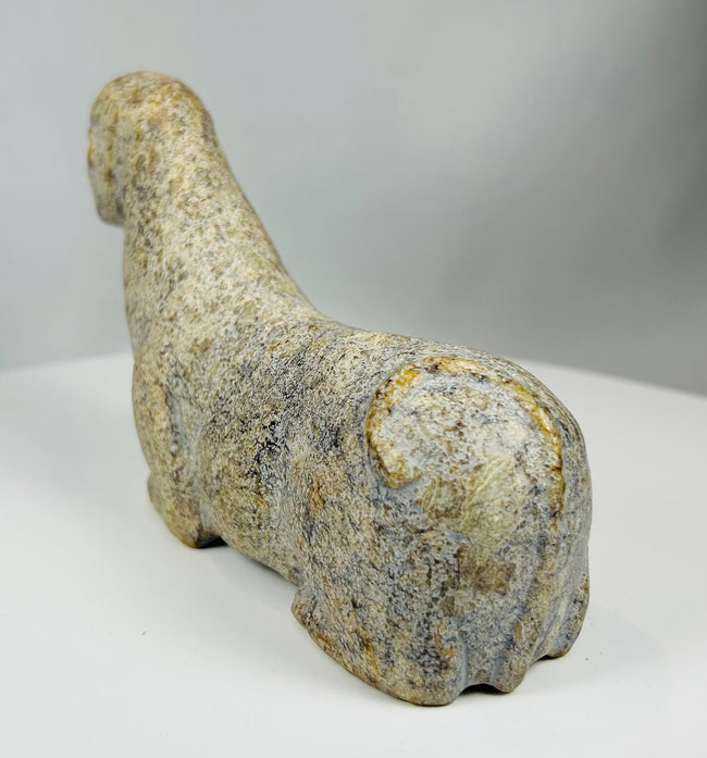 Traditional African carved stone figure with symbolic zoomorphic form