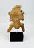 Pre-Columbian terracotta artifact on black museum display stand