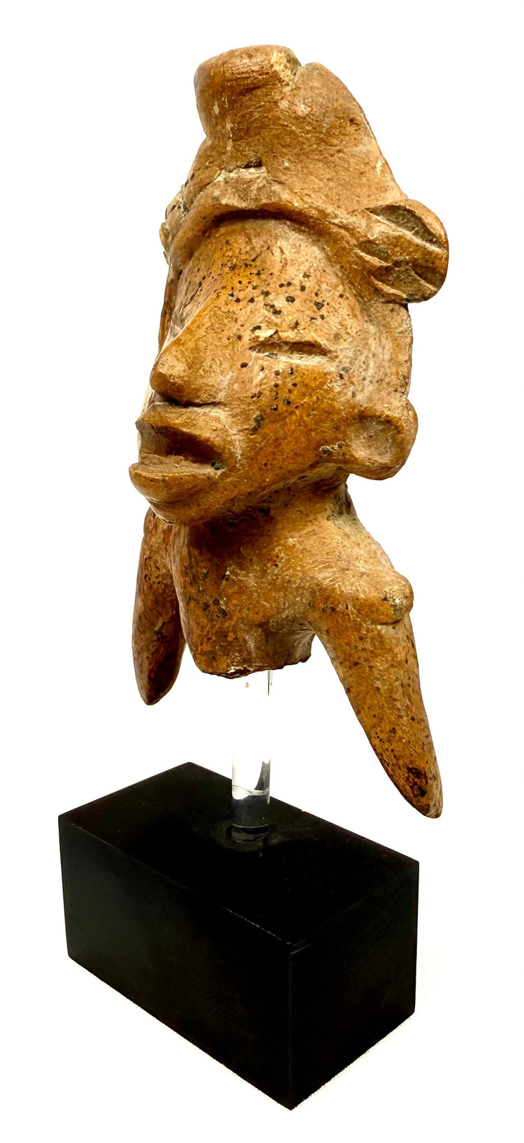 Frontal view of fragmentary terracotta human effigy with stylized headdress