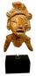 Orange-brown fired clay torso fragment showing incised eyes and textured surface