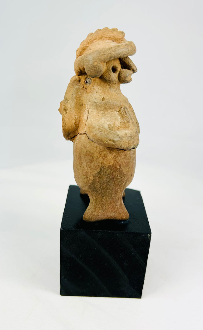 Ancient West Mexican standing effigy, terracotta, perforated back disk, turban headdress, mineral accretions