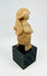 Pre-Columbian terracotta effigy with circular back disk, hand-modeled, 100 BCE–300 CE, museum-style mount