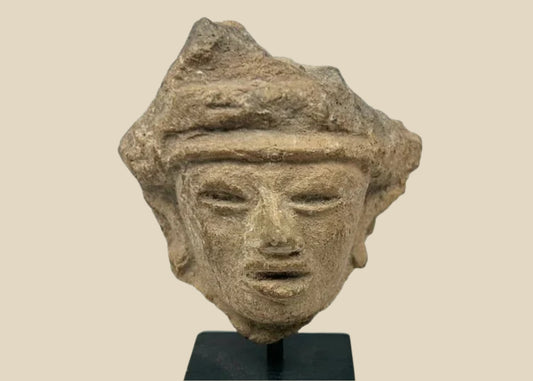 Fragmentary hand-modeled terracotta head of a male figure with almond-shaped eyes, parted lips, raised headband, and stylized coiffure; Western Mexico (Nayarit, Jalisco, or Colima), Late Formative to Early Classic period, circa 200 BCE–300 CE; mounted on custom display stand.