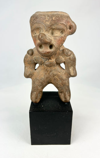 Ancient Pre-Columbian terracotta standing figure from West Mexico (Nayarit/Colima/Jalisco), circa 300 BCE–500 CE, with stylized head, pierced ears, and wide stance, mounted on a black display base, photographed on a white background