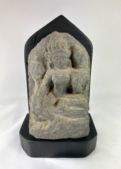 14th-century carved stone stele from West Tibet depicting the Buddhist deity Tara, “Mother of Liberation,” mounted on a black base, showing detailed facial features and traditional iconography, 6 inches tall.