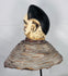 Ethnographic Yoruba Egungun mask headdress showcasing carved facial scarification and traditional masquerade construction.