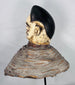 Ethnographic Yoruba Egungun mask headdress showcasing carved facial scarification and traditional masquerade construction.