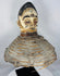 Mid-20th century Yoruba Egungun ceremonial headdress with white-painted face, red eyes, and woven fiber structure.