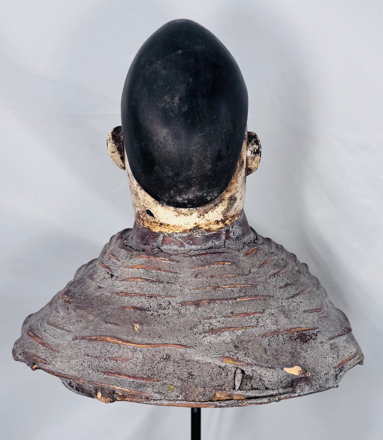 Historic West African Egungun headdress displaying carved ancestral imagery and original woven fiber support.