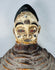 Authentic Yoruba Egungun ceremonial artifact with white pigment, red eyes, and woven costume support structure.