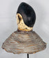 Ceremonial Yoruba masquerade head from Nigeria with weathered painted surface and traditional wicker construction