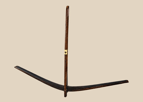 Antique Nu tribal crossbow from Yunnan, China, crafted from mulberry wood with hand-carved bone toggles and aged patina, dating to the Late Qing to early 20th century.