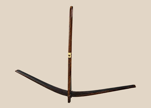 Antique Nu tribal crossbow from Yunnan, China, crafted from mulberry wood with hand-carved bone toggles and aged patina, dating to the Late Qing to early 20th century.