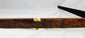 Close-up of Yunnan Nu tribal crossbow stock with carved mulberry wood and bone toggle.
