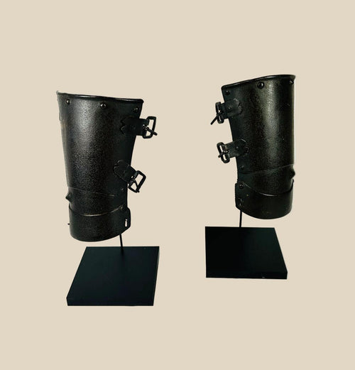 Pair of 14th–15th century European steel vambraces with three articulated plates, raised ulna bosses, and adjustable leather buckles, used for forearm protection in battle or tournaments.