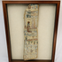 Framed ancient Egyptian painted coffin fragment with polychrome hieroglyphic and figural decoration displayed against a neutral background